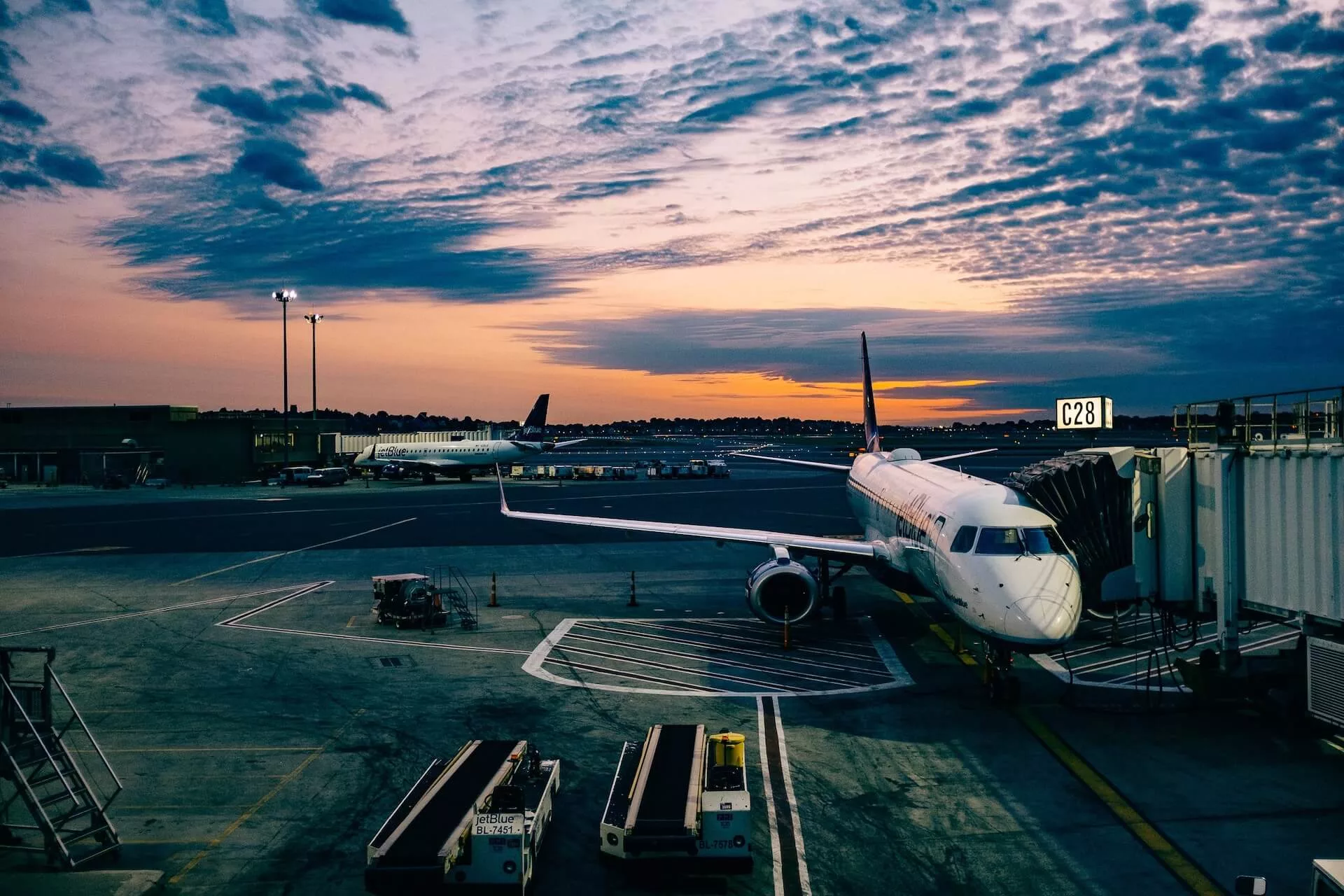 airplane at a terminal at sunrise